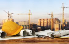 Concept of construction and design. 3d render of blueprints and designer tools on the panorama of construction site.